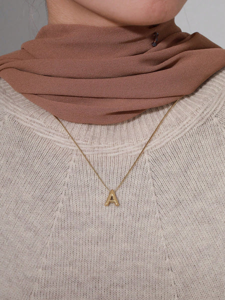 A fashionable stainless steel 14k gold plated letter necklace drop